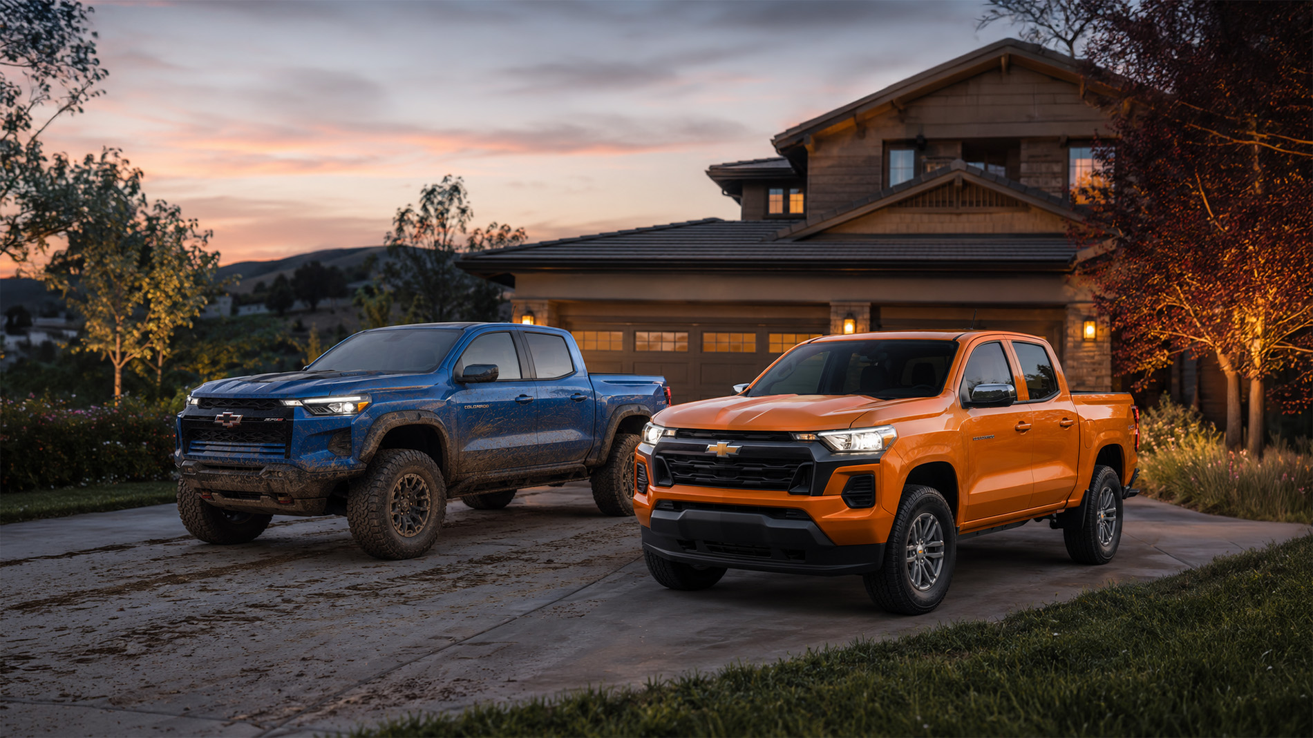 A blue and orange 2026 Chevrolet Colorado parked side by side in a residential driveway at sunset, showcasing the contrast between off‑road and daily‑driver trims available at Delta Chevrolet in Pittsburg, CA.