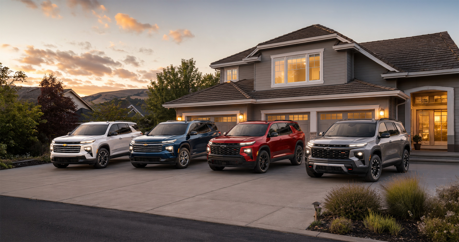 Four 2026 Chevrolet Traverse SUVs in white, blue, red, and gray parked side by side in a residential driveway at sunset, highlighting the range of Traverse trim levels available at Delta Chevrolet in Pittsburg, CA.