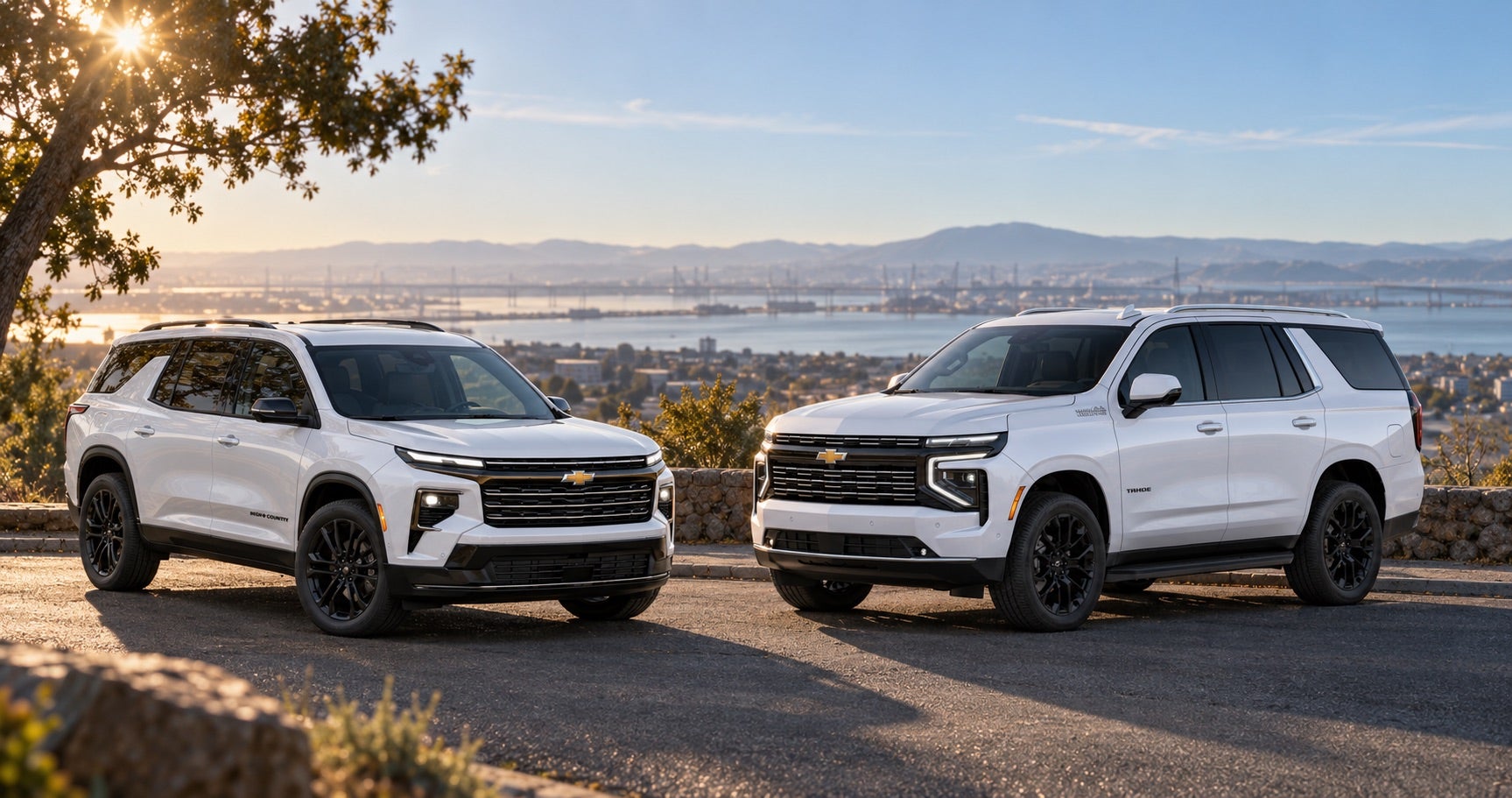 2027 Chevrolet Traverse High Country and Tahoe High Country parked together at a scenic overlook in Pittsburg, CA